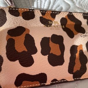 Coach leather animal print coin purse. With attached key chain.